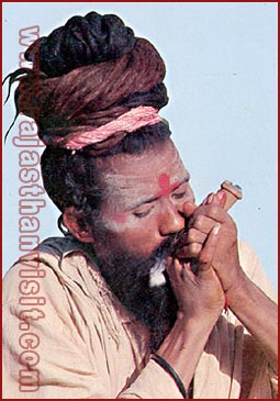 An ascetic smoking 'Chilam' in Ranakpur, Rajasthan